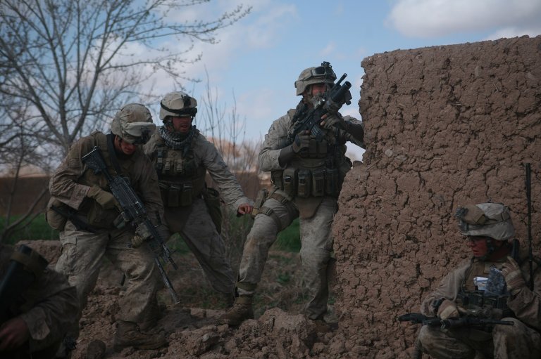 Marines with Bravo Company, 1st Battalion, 6th Marine Regiment, 2nd Marine Division, return fire during combat in Marjah, Afghanistan, Feb. 22, 2010. Marines and sailors with 1/6 took part in Operation Moshtarak, the second largest offensive in the history of Operation Enduring Freedom, aimed at wresting the city of Marjah from Taliban control.
