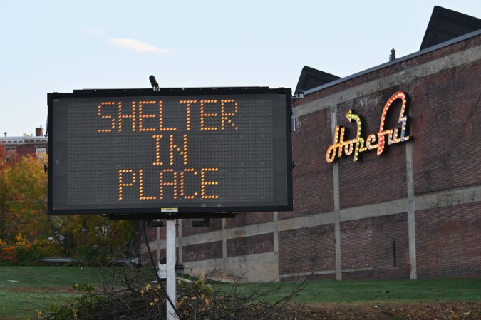 A shelter in place sign is displayed in Lewiston, Maine, on October 27, 2023, in the aftermath of a mass shooting. Hundreds of police in the US state of Maine hunted October 26, 2023 for a fugitive gunman who killed 18 people at a bowling alley and a bar, as President Joe Biden mourned "yet another senseless and tragic mass shooting." Police named the suspect as 40-year-old Robert Card -- seen in surveillance footage pointing a semi-automatic rifle as he walked into the Sparetime Recreation bowling alley. (Photo by ANGELA WEISS / AFP) (Photo by ANGELA WEISS/AFP via Getty Images)