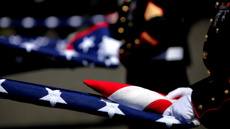 Local Marines fold flags for Lance Cpl. Joe Jackson’s family during his funeral May 4 at Tahoma Cemetery. Jackson was killed April 24 by an improvised explosive device blast in Afghanistan.