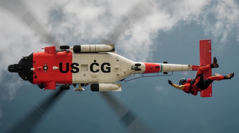 Coast Guard rescue swimmers saved a worker stuck in hardening concrete after roof collapse