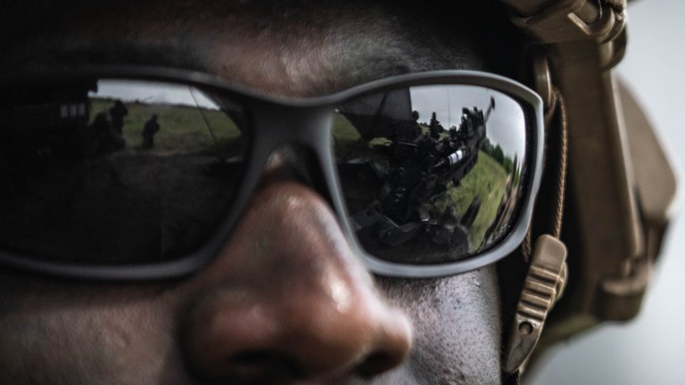 Reflection of an M777 towed 155 mm howitzer off the sunglasses of U.S. Army Sgt. Andrew Head, a section's chief assigned to the 1st Platoon, Archer Battery, Field Artillery Squadron, 2nd Calvary Regiment, during a fire support coordination exercise as part of Griffin Shock 23 held at Bemowo Piskie, Poland, May 18, 2023. As the framework nation in Poland, Exercise Griffin Shock demonstrates the U.S. Army's ability to assure the NATO alliance by rapidly reinforcing the NATO Battle Group Poland to a brigade-size unit. (U.S. Army National Guard photo by Staff Sgt. Agustín Montañez)