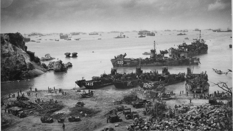 A black and white image showing American landing craft reaching the beaches of Okinawa in 1945.
